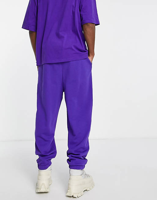 Tracksuits COLLUSION oversized joggers with logo heart print in purple acid wash 