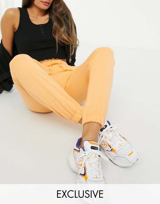 orange stacked sweatpants