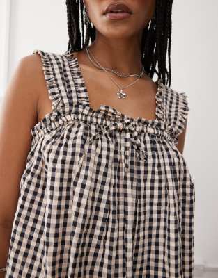 COLLUSION smock swing dress in beige and black gingham