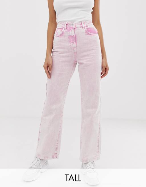 High-waisted pink jeans with visible buttons