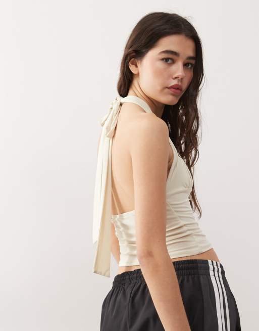 COLLUSION Top sinuoso allacciato al collo color panna taglio