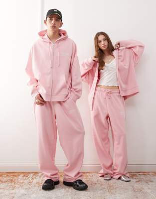 COLLUSION Unisex - Locker geschnittene Jogginghose in Rosa mit Koordinaten-Print, Kombiteil