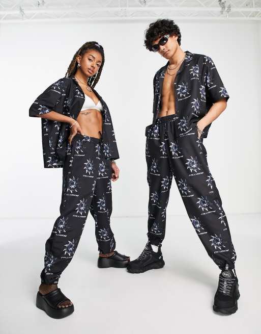 Collusion Unisex Noughties Fit Sweatpants With All Over Print In Black