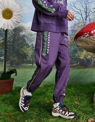 COLLUSION Unisex oversized woven joggers with character print in purple