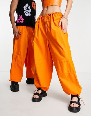 COLLUSION Unisex parachute trousers in orange