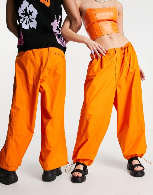 Weekday Unisex parachute baggy pants in orange exclusive to ASOS