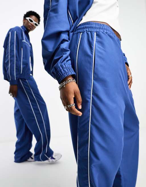 COLLUSION Unisex track pants in blue - part of a set