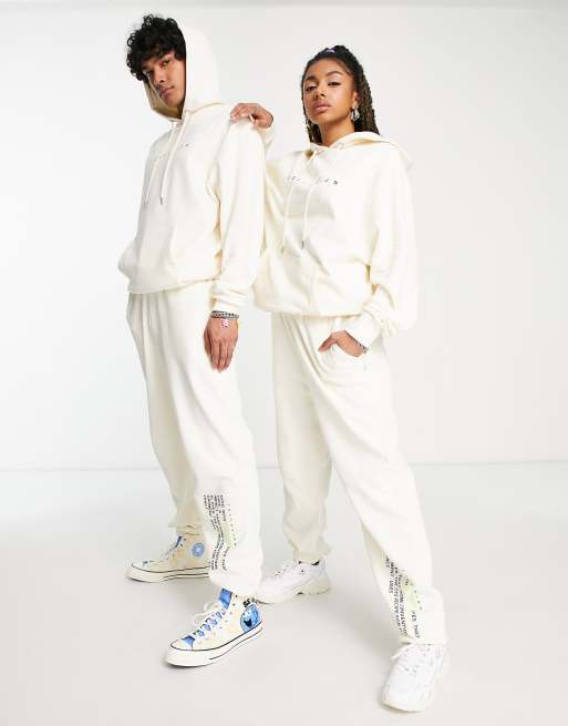 COLLUSION Unisex trackies with text print in ecru (part of a set)