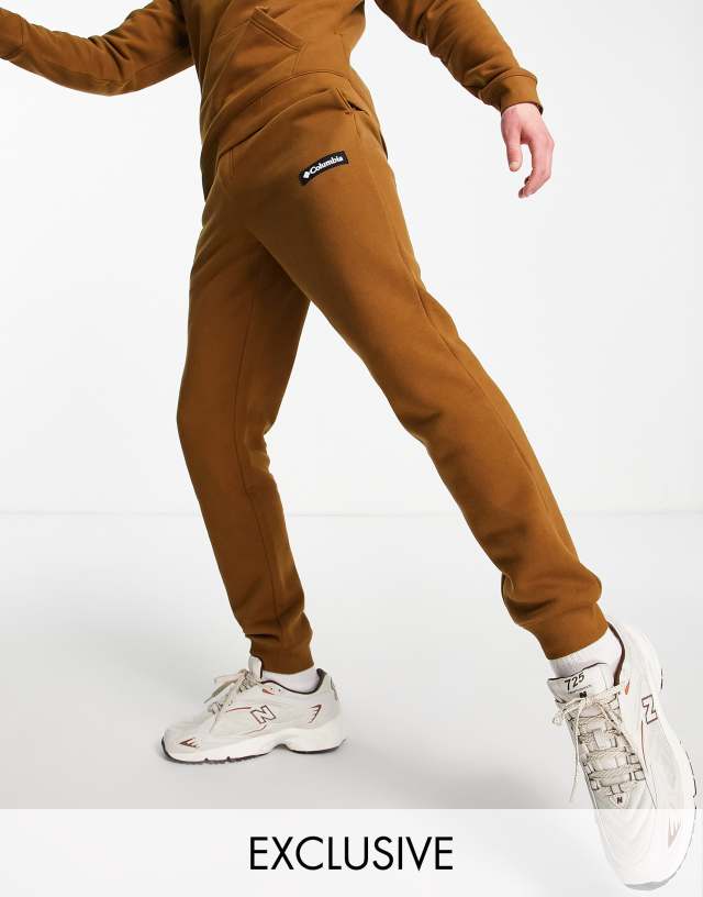 Columbia Cliff Glide sweatpants in brown Exclusive at ASOS