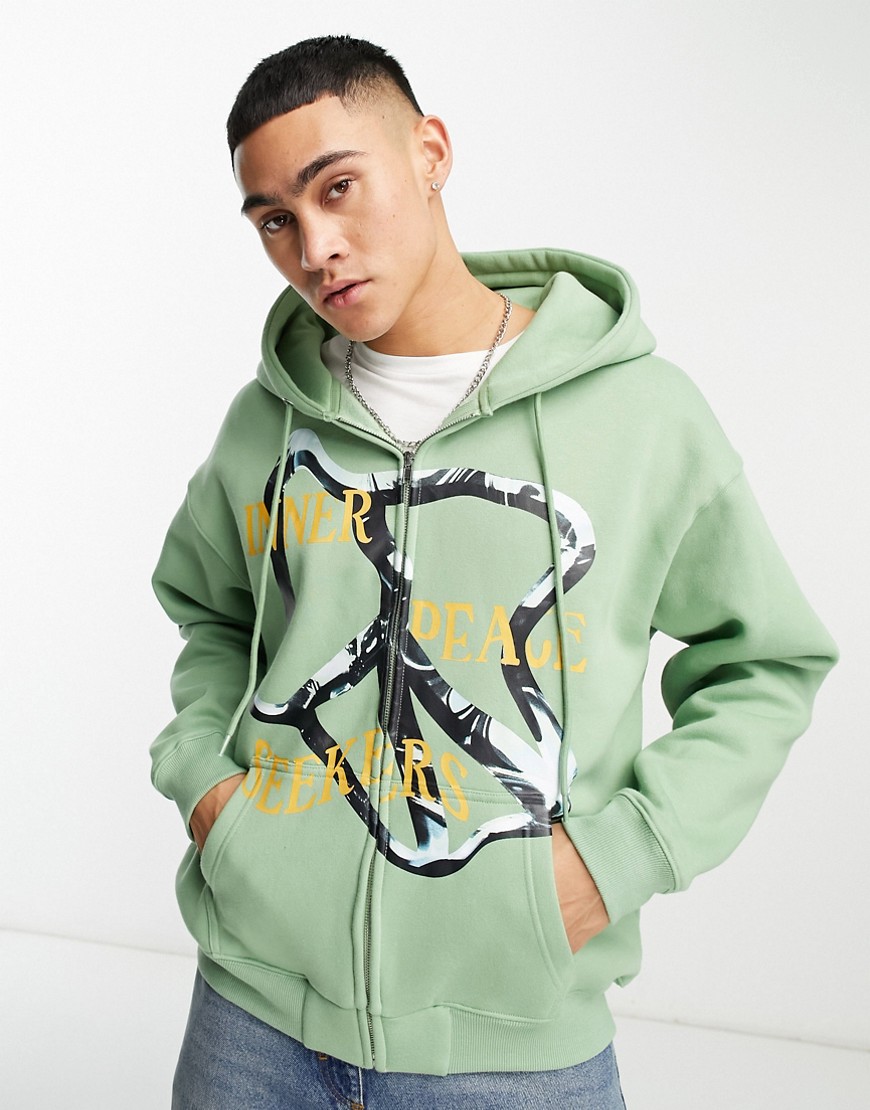 Coney Island Picnic seekers zip through hoodie in dusty green with graphic print