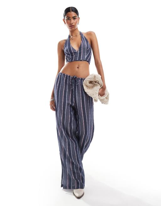 Conjunto morado de chaleco a rayas con cuello halter y pantalones de pernera recta con lazada en la cintura de Mango