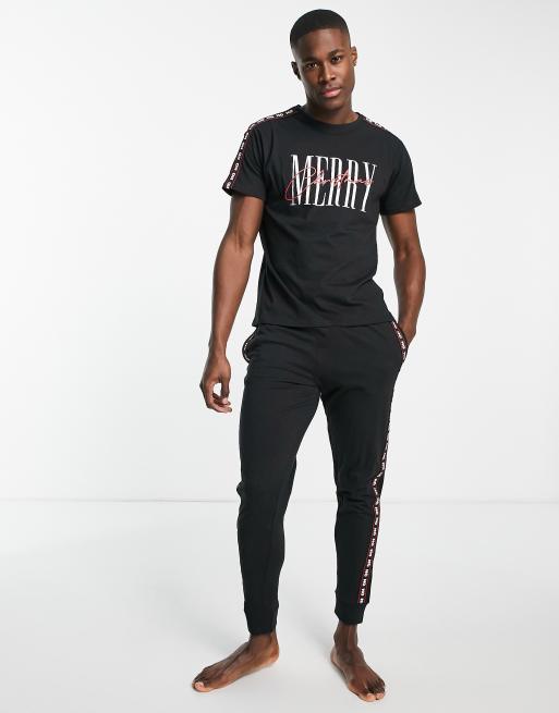 Conjunto negro de estar por casa con texto navideño de Threadbare
