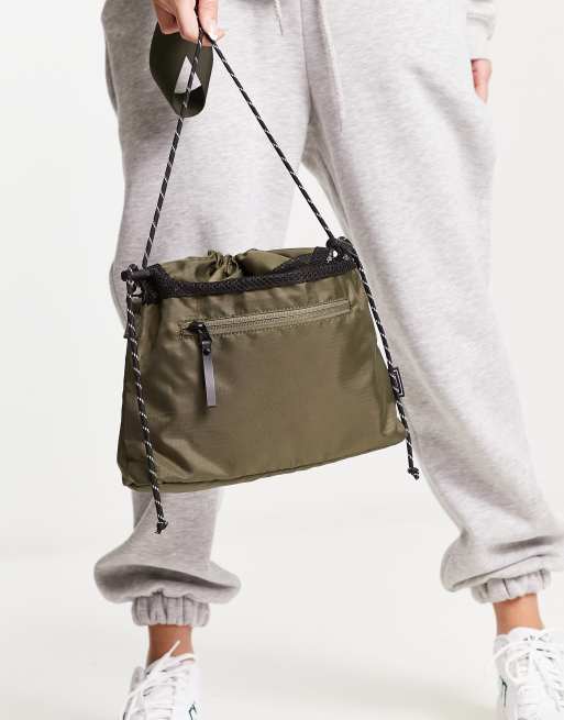 Consigned drawstring crossbody bag in khaki ASOS