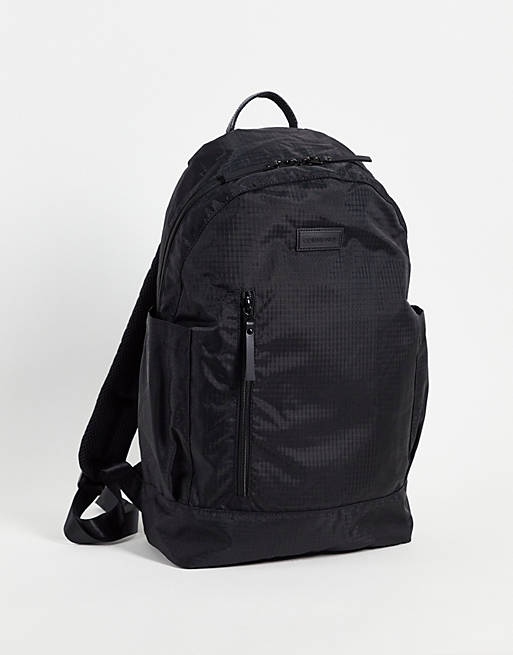 Consigned slim profile backpack