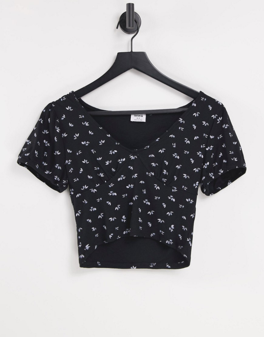 Cotton: On button through short sleeve top in black floral