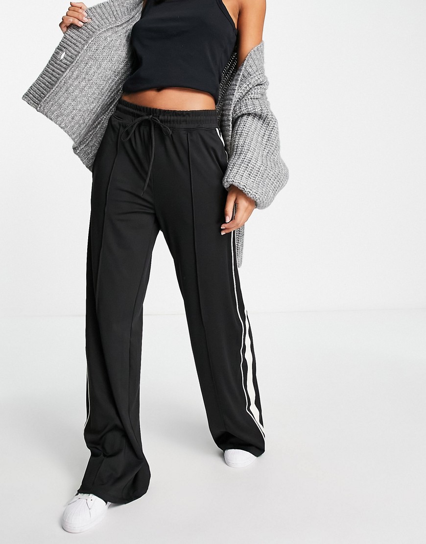 Cotton: On wide leg track pants with side panel in black