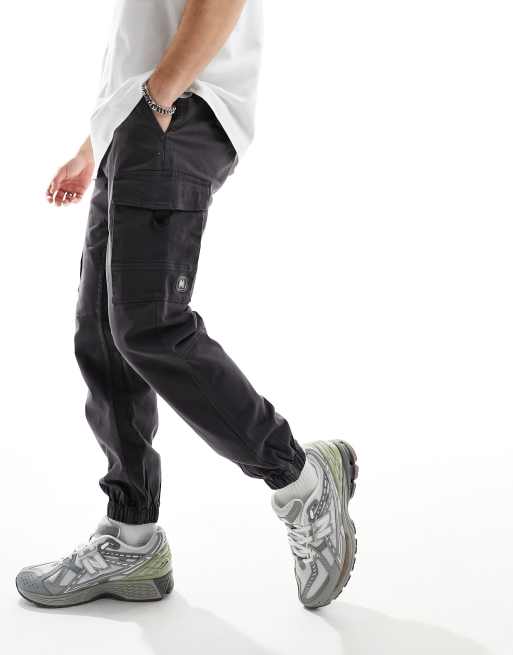 Criminal Damage cargo pants with side leg army pockets in grey