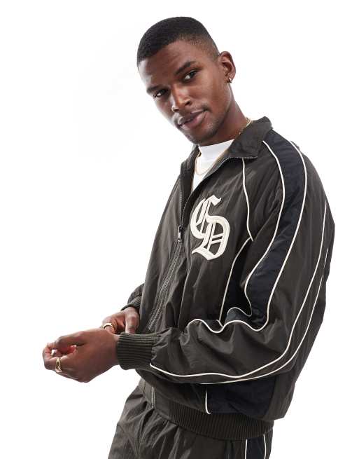 Criminal Damage Panelled training jacket in black/chocolate