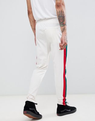 white joggers with red stripe