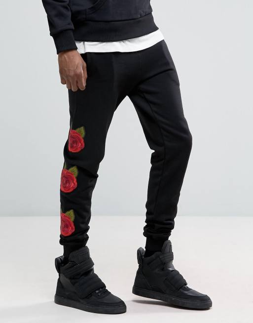 Criminal Damage Skinny Sweatpants In Black With Rose Print