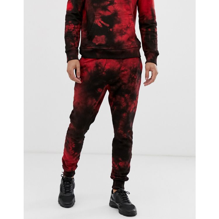 Criminal Damage tie dye sweatpants in black and red