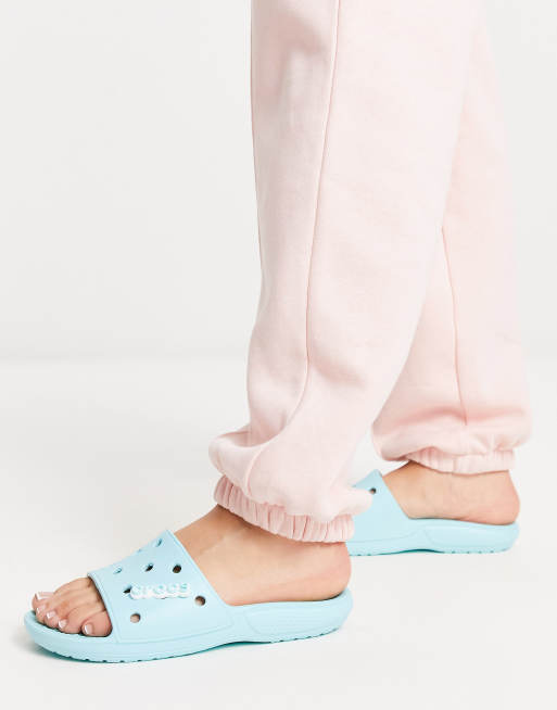 Crocs classic slide flat sandals in ice blue | ASOS