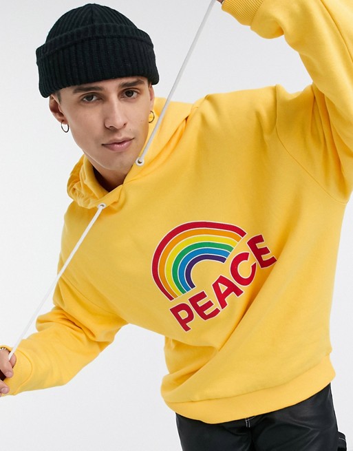 Crooked Tongues oversized yellow hoodie with rainbow peace print