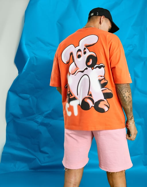 Crooked Tongues – Pomarańczowy T-shirt oversize z nadrukiem z psem na plecach