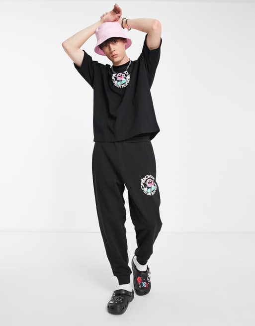 Crooked Tongues relaxed trackies with skateboard CT man graphic print in black (Part of a set)