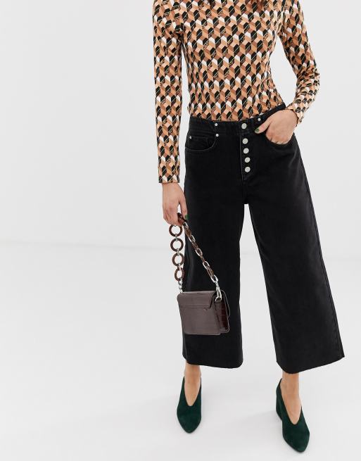 Culottes de pernera ancha con botones en la parte delantera en denim negro de River Island