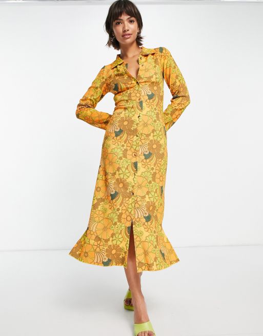 Damson Madder - Varm gul midikjole med gennemgående knapper og 70'er-blomstermønster i polyester
