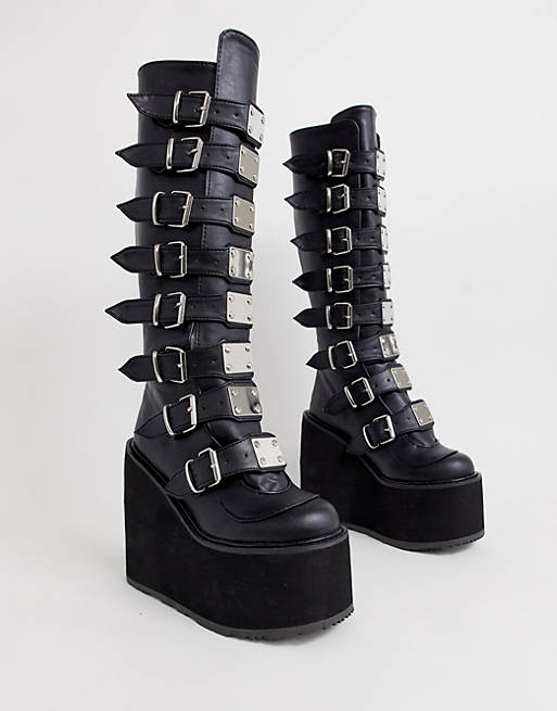Demonia Swing buckle flatform knee boots in black | ASOS