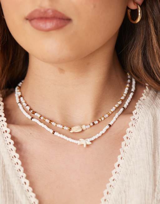 DesignB London - Meerlaagse ketting met kralen en hangers van zeester en schildpad