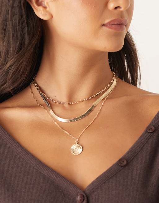 DesignB London - Meerlaagse ketting met slangen-schakelketting en parelhangertje in goud