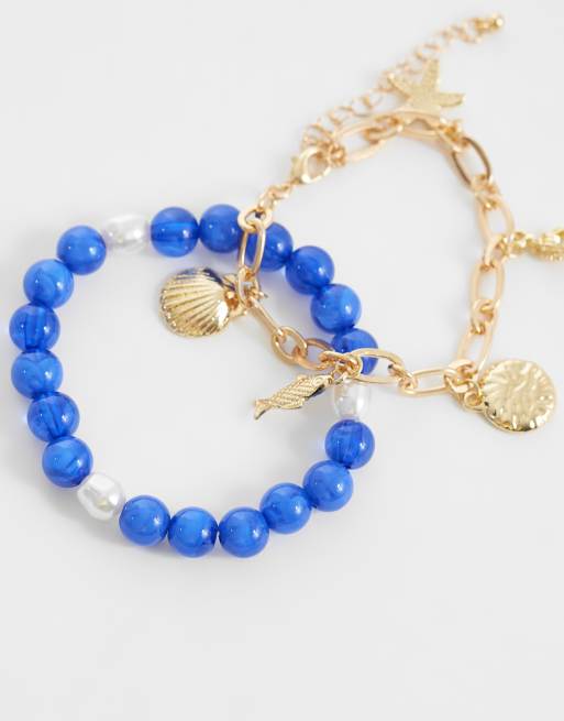 DesignB London - Pack de 2 pulseras añil y dorada con cuentas y charms marinos, 2 de 3