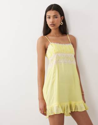 Dippin' Daisy's babydoll beach mini dress with lace detailing in vanilla custard