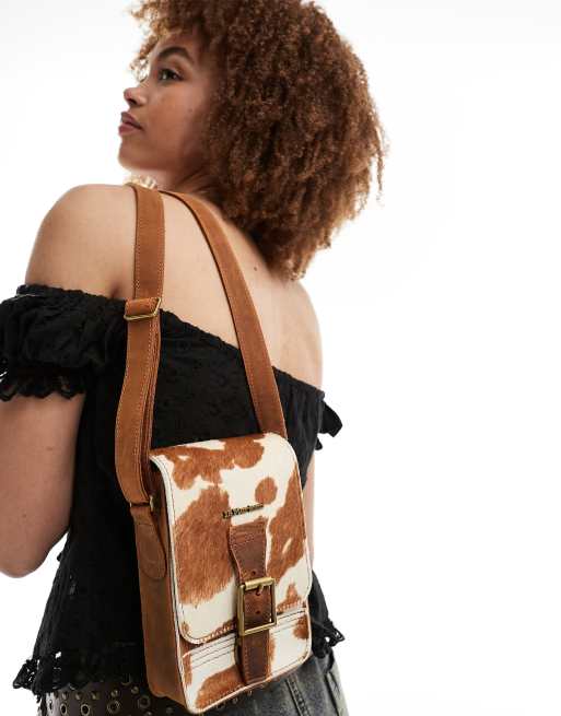 Dr Martens jersey cow print reporter bag in tan | ASOS