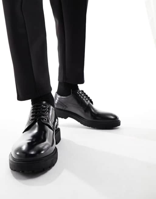 Dune - Leren brogues met dikke zool in zwart lakleer