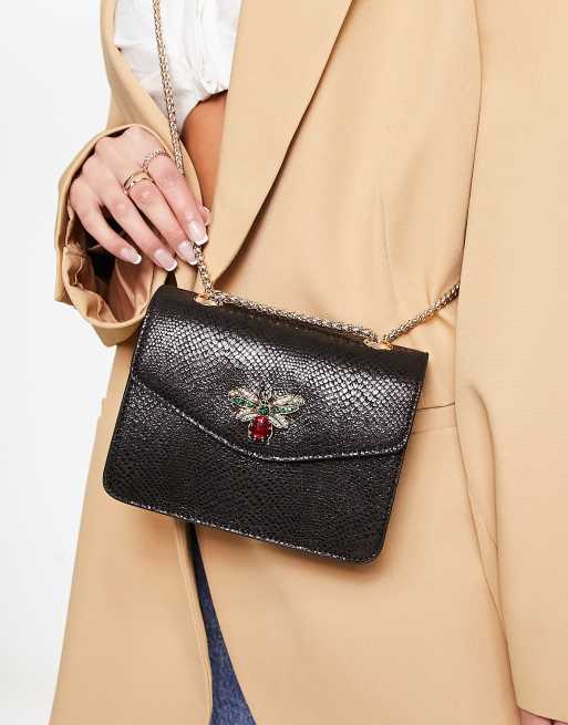 Dune metallic reptile cross body bag with bug hardware in black