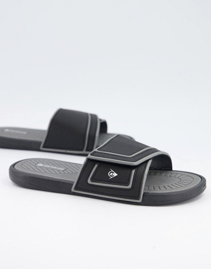 Dunlop – Svarta sliders med logga i sidan