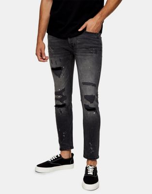 фото Эластичные зауженные джинсы черного выбеленного цвета из органического хлопка, со рваной отделкой и эффектом брызг краски topman-черный цвет