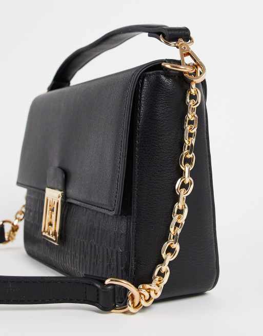 Black cross body store bag with gold chain