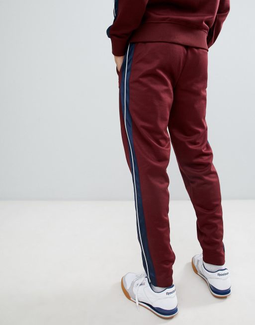 ellesse Cassed sweatpants with taping in burgundy