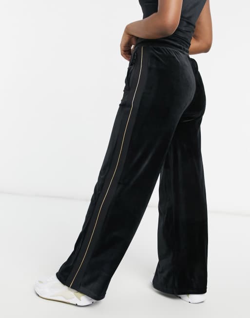 ellesse high waisted joggers in black and gold ASOS