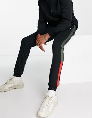 ellesse joggers with khaki & red stripe in black