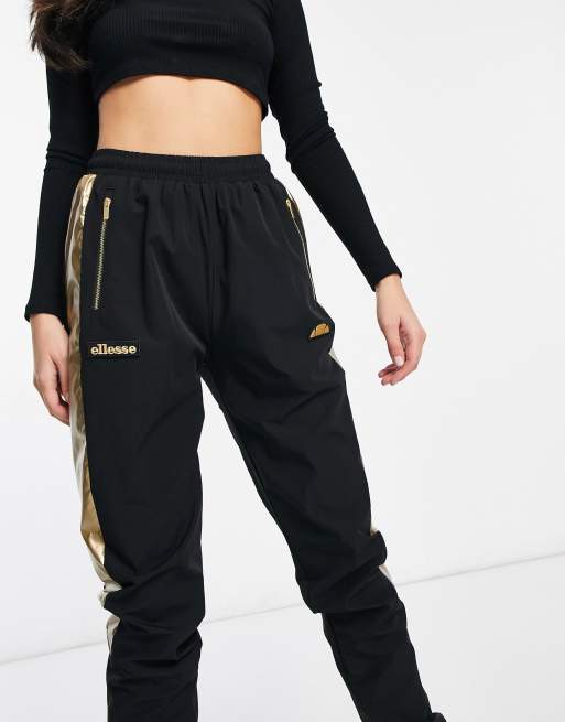 Black and store gold track pants