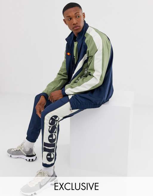 ellesse – Recycelter Trainingsanzug in Marineblau mit Bahnendesign, 2 von 3