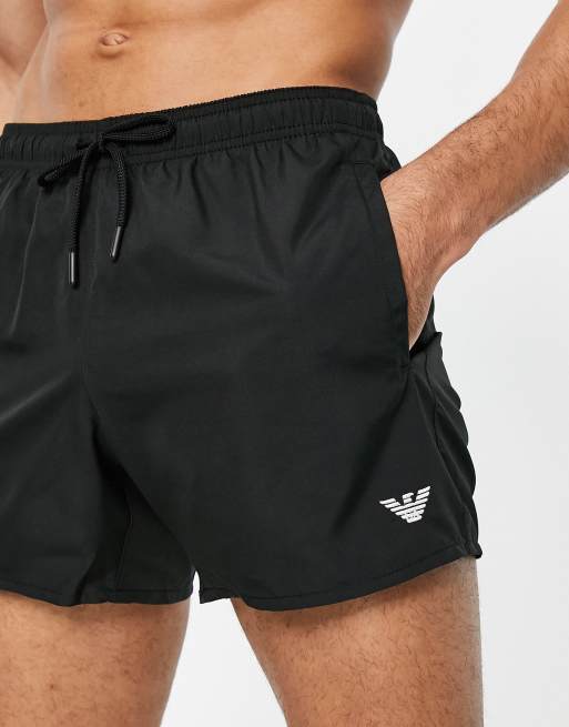Emporio Armani eagle logo swim shorts in black | ASOS