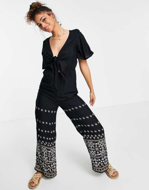 En Crème – Jumpsuit mit weitem Beinschnitt, Schnürung vorn und Paisley-Detail