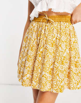 En Crème En Crème mini pleated skirt in yellow paisley with tie waist co-ord